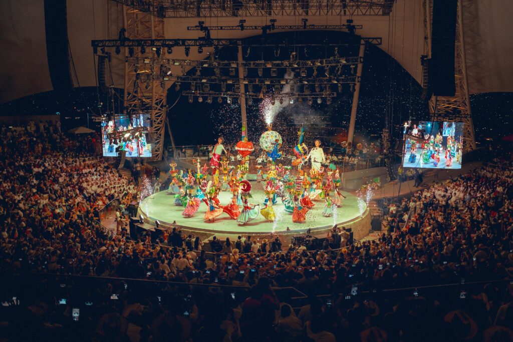 Lively celebration of traditional dance at the Guelaguetza festival in Oaxaca, Mexico, with colorful costumes.